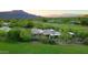 Aerial view of home on golf course with mountain views and desert landscaping at 1637 N Quartz Valley Rd, Scottsdale, AZ 85266