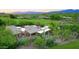 Aerial view of desert home with lush green golf course and mountain views at 1637 N Quartz Valley Rd, Scottsdale, AZ 85266