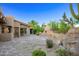 Outdoor patio featuring a fireplace and water feature with desert landscaping at 1637 N Quartz Valley Rd, Scottsdale, AZ 85266