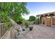 Backyard patio featuring desert landscaping, rock water feature and blooming flowers at 1637 N Quartz Valley Rd, Scottsdale, AZ 85266