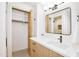 Stylish bathroom offers wood-finish cabinets, quartz countertop, and an open closet for storage at 1637 N Quartz Valley Rd, Scottsdale, AZ 85266