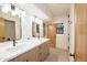 Bathroom features double sink vanity, wood cabinets, and modern light fixtures at 1637 N Quartz Valley Rd, Scottsdale, AZ 85266
