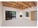 Spacious bedroom with wood beam ceiling, fireplace, and a large sliding door showcasing desert views at 1637 N Quartz Valley Rd, Scottsdale, AZ 85266