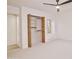 Bright bedroom featuring carpeted floors, a ceiling fan, and closet with folding doors at 1637 N Quartz Valley Rd, Scottsdale, AZ 85266