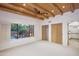Light-filled bedroom boasts a wood beam ceiling, and views of the tranquil pool and waterfall feature at 1637 N Quartz Valley Rd, Scottsdale, AZ 85266