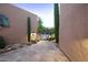 Stone paved courtyard featuring desert landscaping, custom lighting, and a decorative metal gate at 1637 N Quartz Valley Rd, Scottsdale, AZ 85266