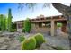 Desert home with lush cactus landscaping, stone features, and warm natural light at 1637 N Quartz Valley Rd, Scottsdale, AZ 85266