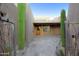 Entrance of home featuring desert landscaping, a stone path, and a custom wood door at 1637 N Quartz Valley Rd, Scottsdale, AZ 85266