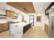 Modern kitchen featuring an island with marble countertop and custom wooden cabinets at 1637 N Quartz Valley Rd, Scottsdale, AZ 85266