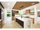Well-lit kitchen featuring a marble countertop island, modern appliances and custom cabinetry at 1637 N Quartz Valley Rd, Scottsdale, AZ 85266