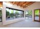 Living room with ceiling beams, a chandelier, large windows with views of the yard and desert landscaping at 1637 N Quartz Valley Rd, Scottsdale, AZ 85266