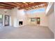Bright living room boasting a fireplace, wood beam ceiling, and open access to outdoor views at 1637 N Quartz Valley Rd, Scottsdale, AZ 85266