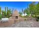 Backyard grill with nearby fireplace and desert landscape with a water feature at 1637 N Quartz Valley Rd, Scottsdale, AZ 85266
