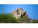 Desert landscape featuring large rock formation with lush green foliage at 1637 N Quartz Valley Rd, Scottsdale, AZ 85266