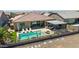 Aerial view of the backyard with a pool, outdoor kitchen, seating areas, and desert landscaping at 17018 W Saguaro Park Ln, Surprise, AZ 85387