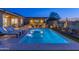Stunning backyard pool area with a pergola, outdoor seating, and a built-in grill, perfect for entertaining at 17018 W Saguaro Park Ln, Surprise, AZ 85387