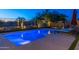 Inviting backyard with a sparkling pool, comfortable lounge chairs, and lush desert landscaping, creating a serene retreat at 17018 W Saguaro Park Ln, Surprise, AZ 85387