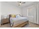 Bedroom featuring ceiling fan, wood floors, and natural light from window at 17018 W Saguaro Park Ln, Surprise, AZ 85387