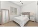 Bedroom features neutral decor, carpet flooring, and a full-length mirror at 17018 W Saguaro Park Ln, Surprise, AZ 85387