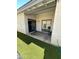 Covered back patio with artificial turf and a sliding glass door to the interior at 1718 S Longmore St # 53, Mesa, AZ 85202