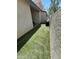Side yard featuring artificial turf for a lush, low-maintenance landscape and stucco wall at 1718 S Longmore St # 53, Mesa, AZ 85202