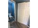 Bathroom with a wooden floor, blue walls, and a vanity with a dark cabinet and neutral countertop at 1718 S Longmore St # 53, Mesa, AZ 85202