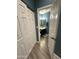 Bathroom with a wooden floor, blue walls, and a vanity with a dark cabinet and neutral countertop at 1718 S Longmore St # 53, Mesa, AZ 85202