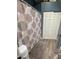 Bathroom with tub/shower, white tile, and blue walls with wood-look flooring and a sliding door closet at 1718 S Longmore St # 53, Mesa, AZ 85202