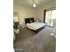 Bedroom with carpet, ceiling fan, and glass patio door to backyard at 1718 S Longmore St # 53, Mesa, AZ 85202