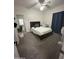 Bedroom with carpet, ceiling fan, and glass patio door to backyard at 1718 S Longmore St # 53, Mesa, AZ 85202