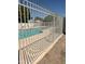 Community pool area enclosed by a secure fence, offering residents a refreshing and safe recreational space at 1718 S Longmore St # 53, Mesa, AZ 85202