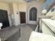 Inviting front porch with stylish stone, secure wrought iron door, and outdoor lighting at 1718 S Longmore St # 53, Mesa, AZ 85202