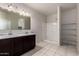 Bathroom features double sink vanity, shower, and built-in shelves for storage at 1748 W Cameron Blvd, Coolidge, AZ 85128