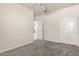 Carpeted bedroom with neutral walls, featuring a ceiling fan and closet with sliding doors at 1748 W Cameron Blvd, Coolidge, AZ 85128