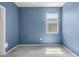 A blue bedroom featuring tile floors and a window with natural light at 1748 W Cameron Blvd, Coolidge, AZ 85128