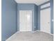A blue bedroom featuring tile floors, and a double door closet at 1748 W Cameron Blvd, Coolidge, AZ 85128