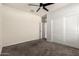 This bedroom features neutral walls, carpet flooring, closet and ceiling fan at 1748 W Cameron Blvd, Coolidge, AZ 85128
