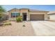 Charming single-story home with well-maintained landscaping, a two-car garage and inviting curb appeal at 1748 W Cameron Blvd, Coolidge, AZ 85128