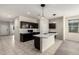 A spacious kitchen with a marble island, stainless steel appliances, and modern lighting fixtures at 1748 W Cameron Blvd, Coolidge, AZ 85128