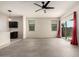 An open living space with ceramic tile floors, a ceiling fan, and a view of the kitchen and backyard at 1748 W Cameron Blvd, Coolidge, AZ 85128