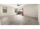 A spacious living room featuring ceramic tile floors, a modern ceiling fan, and a sliding door to the outside at 1748 W Cameron Blvd, Coolidge, AZ 85128