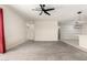 A large living room with ceramic tile flooring, a modern ceiling fan, and an adjacent kitchen at 1748 W Cameron Blvd, Coolidge, AZ 85128