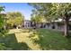 Grassy backyard with a shed and mature trees, creating a serene and private outdoor space at 1825 E Palo Verde Dr, Phoenix, AZ 85016