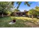 Lush backyard with a charming patio, mature trees, and serene landscaping at 1825 E Palo Verde Dr, Phoenix, AZ 85016