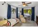 Cozy bedroom featuring ample natural light, a ceiling fan, and fun decor at 1825 E Palo Verde Dr, Phoenix, AZ 85016