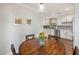 Charming dining area features a round wooden table and is conveniently adjacent to the updated kitchen at 1825 E Palo Verde Dr, Phoenix, AZ 85016
