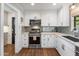 Well-appointed kitchen featuring white cabinets, stainless steel appliances, and modern finishes at 1825 E Palo Verde Dr, Phoenix, AZ 85016