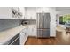 Modern kitchen features white cabinets, stainless steel appliances, and a wine rack at 1825 E Palo Verde Dr, Phoenix, AZ 85016