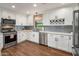 Modern kitchen with white cabinets, stainless steel appliances, and gray tile backsplash at 1825 E Palo Verde Dr, Phoenix, AZ 85016