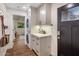 Convenient laundry room with updated cabinets, stacked washer and dryer, and stylish wallpaper at 1825 E Palo Verde Dr, Phoenix, AZ 85016